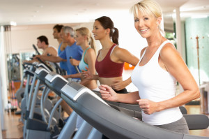 Senior Woman On Running Machine In Gym