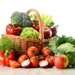 Vegetables in wicker basket isolated on white